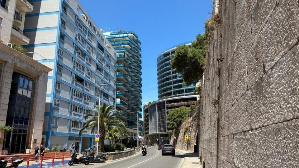 Ocean Village beneath the Rock of Gibraltar Modern apartment buildings near Ocean Village Gibraltar with palm trees, contemporary architecture and an urban streetscape beneath the Rock of Gibraltar.